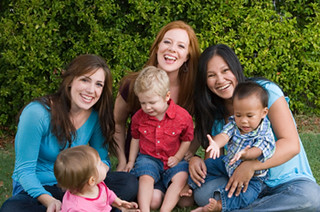 Three moms holding their children whom they will want to protect though life insurance.